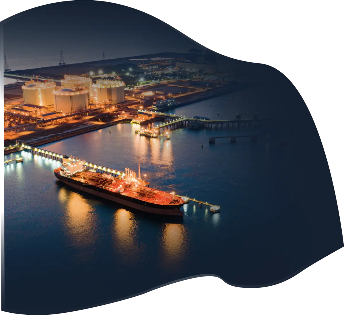 Tanker berthed at an illuminated oil terminal